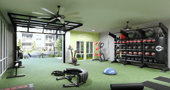 a home gym with weights and a ceiling fan
